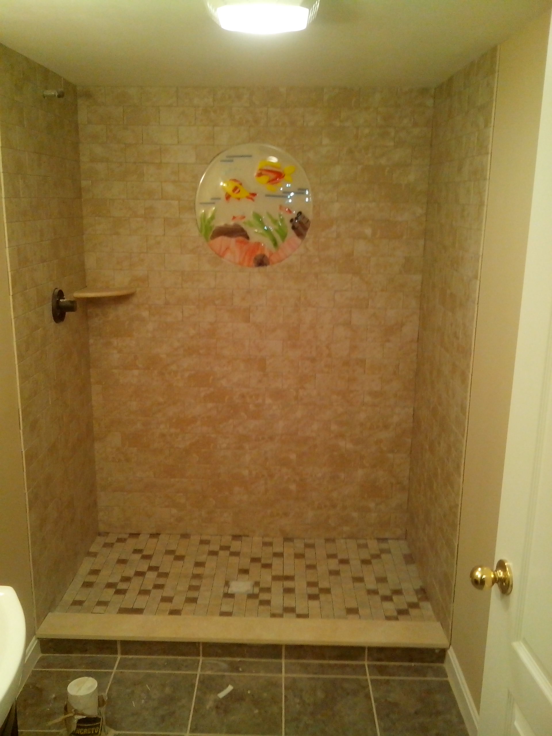 Walk-in shower with custom wall and floor tile