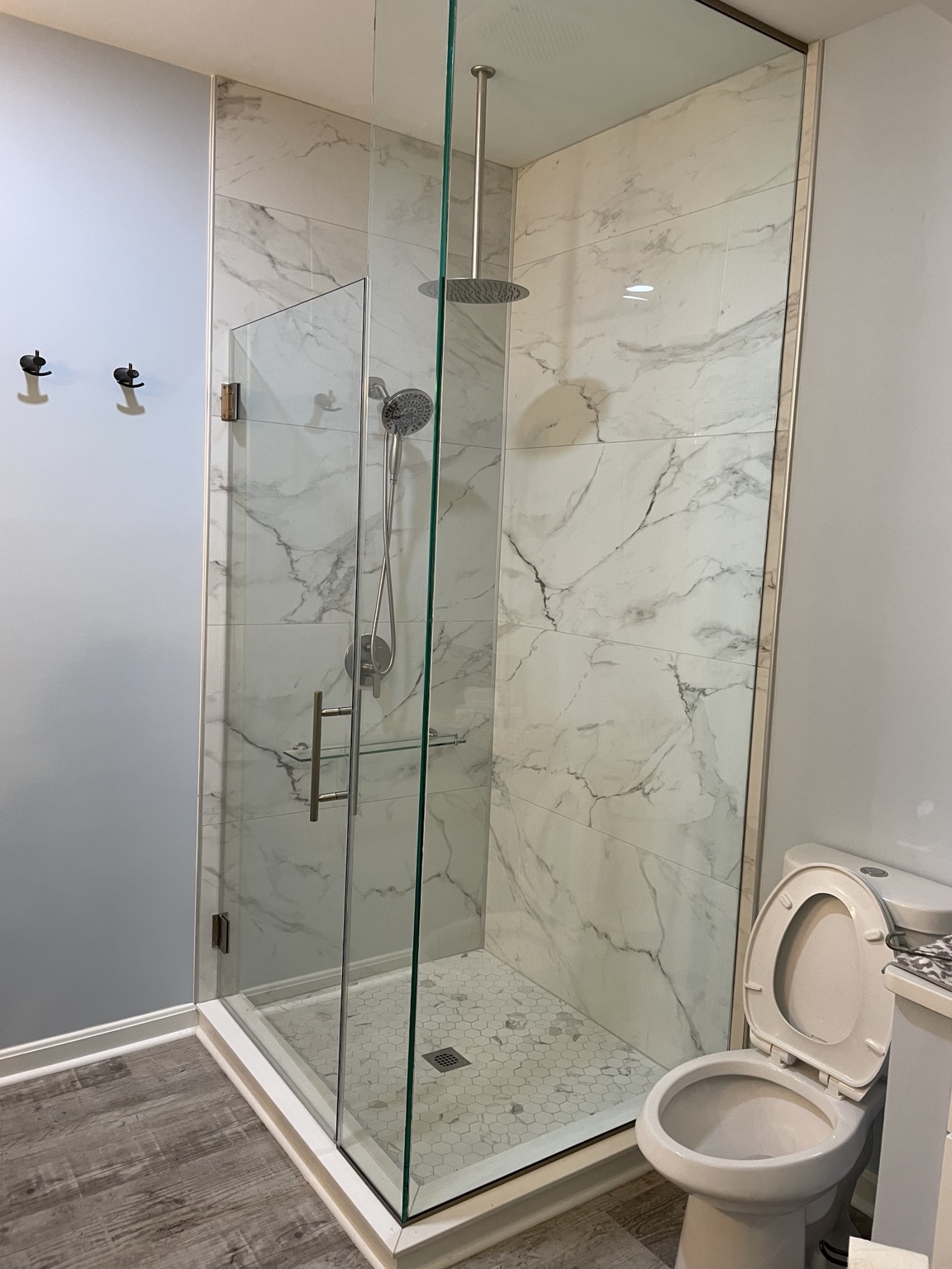 Completed bathroom with a large glass-enclosed walk-in shower