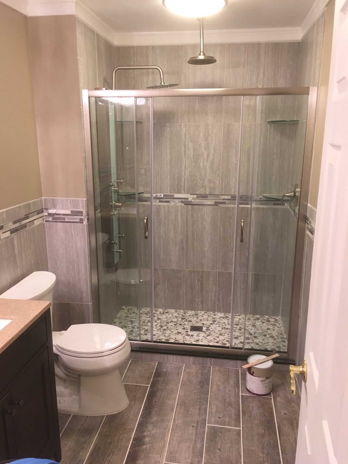 Finished bathroom with glass shower and wood-look tile flooring